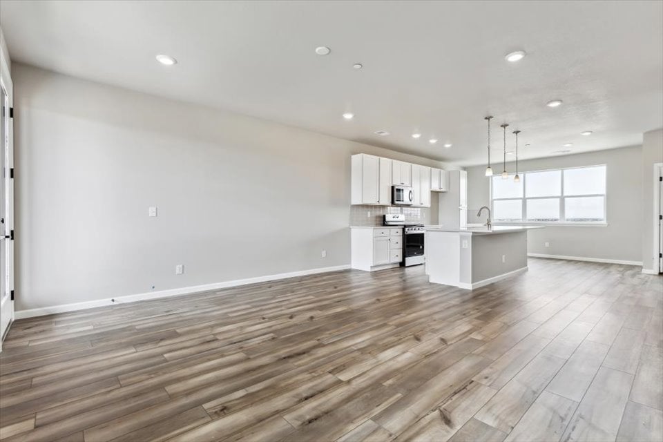 A kitchen with white cabinets.