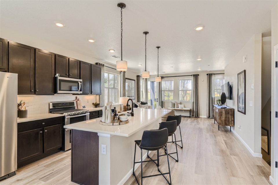 A kitchen with black cabinets.