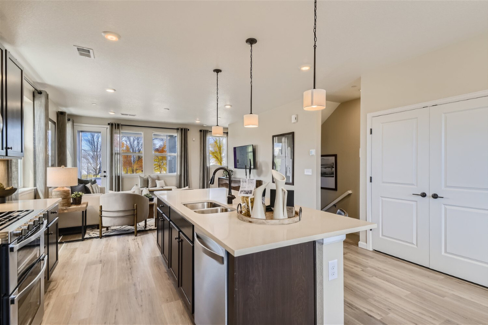 A kitchen with white cabinets.