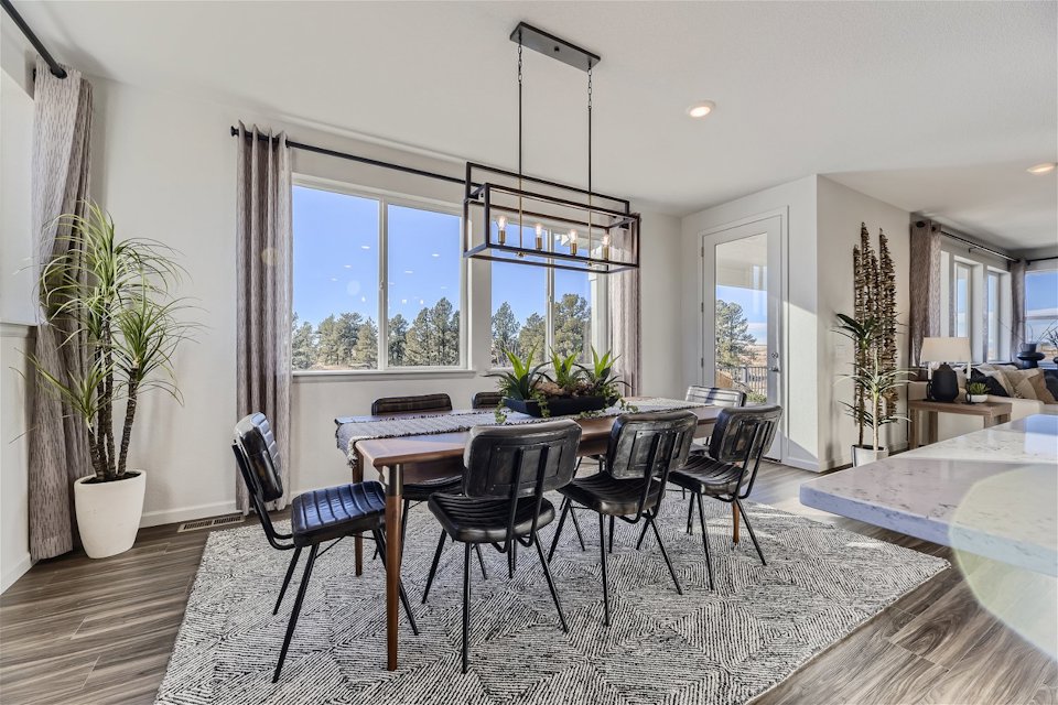 A dining room with a large window.