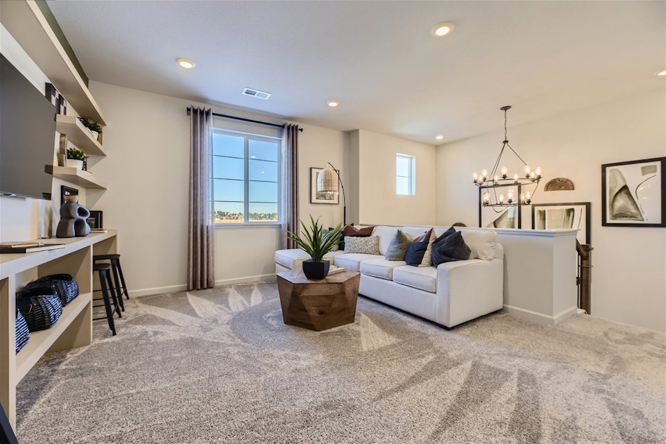 A living room with a couch and a table.