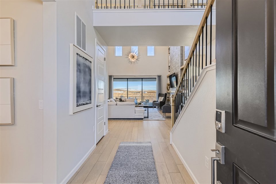 A room with a staircase and a table.