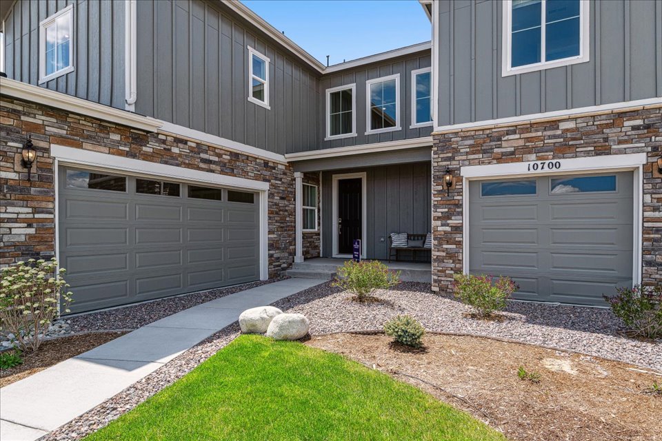 A building with garages and a lawn.