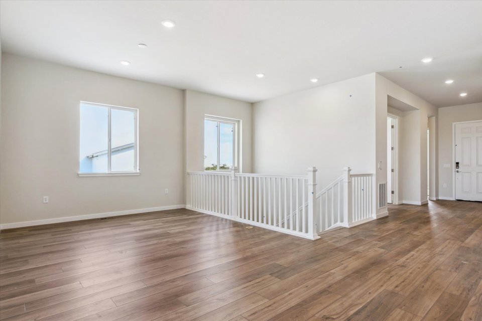 A room with a wood floor and white walls.