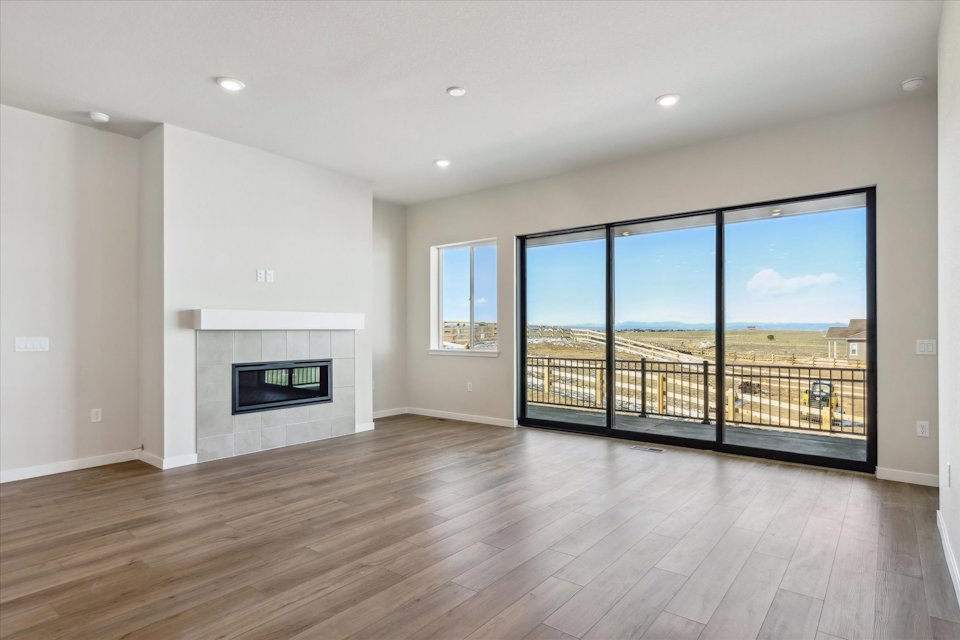 A room with a fireplace and a large window.