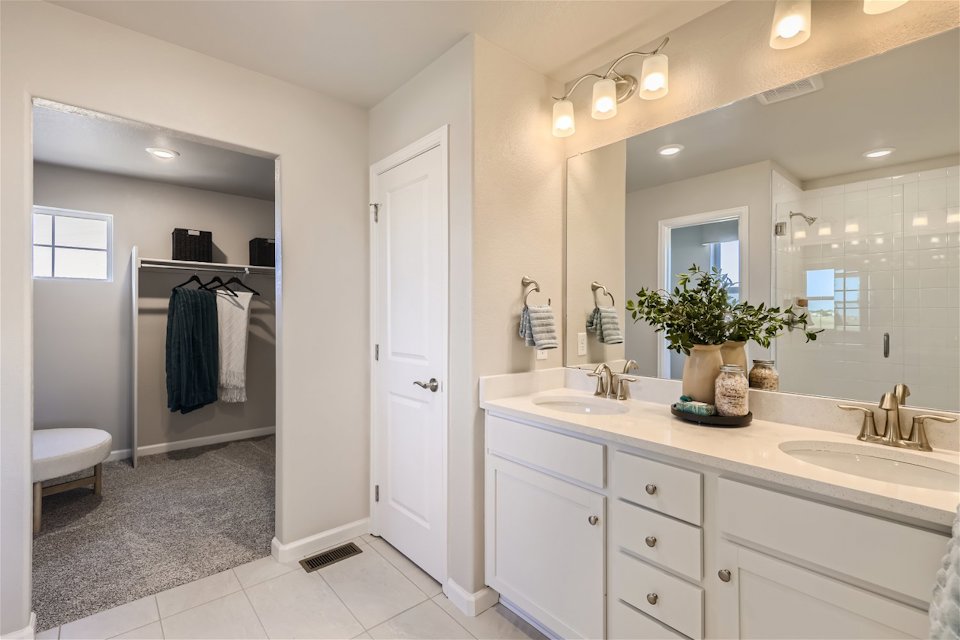 A bathroom with a large mirror.