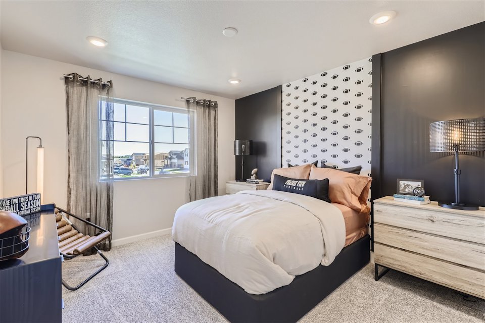 A bedroom with a bed and a window.