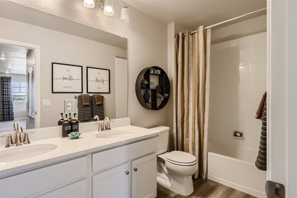 A bathroom with a tub sink and toilet.