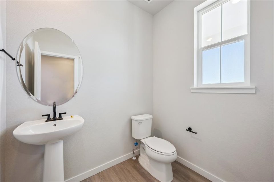 A bathroom with a mirror and sink.
