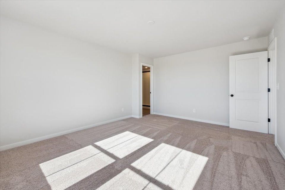 A room with white walls and a rug.