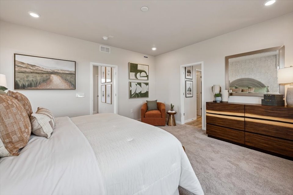 A bedroom with a bed and a desk.