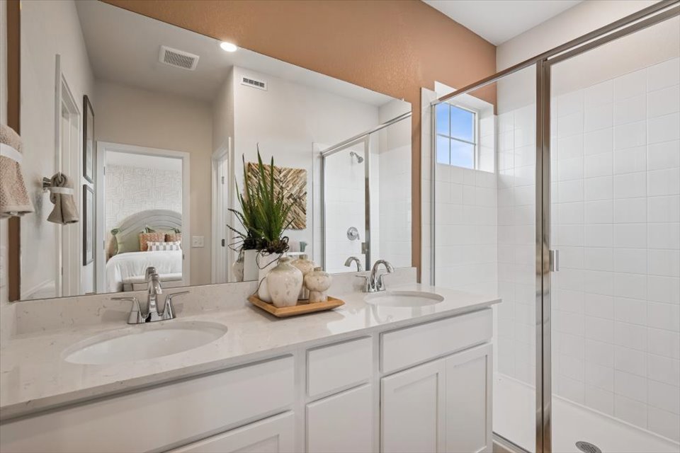 A bathroom with a large mirror.