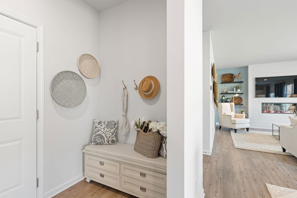 A room with a white wall and a white door with a white dresser and a white door with.
