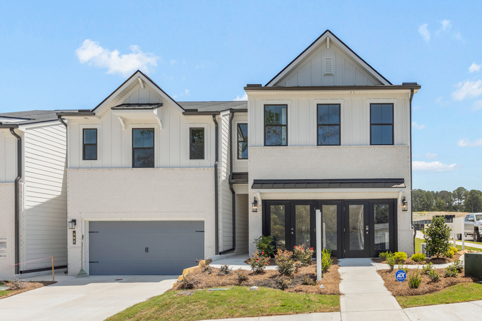 A white house with a garage.