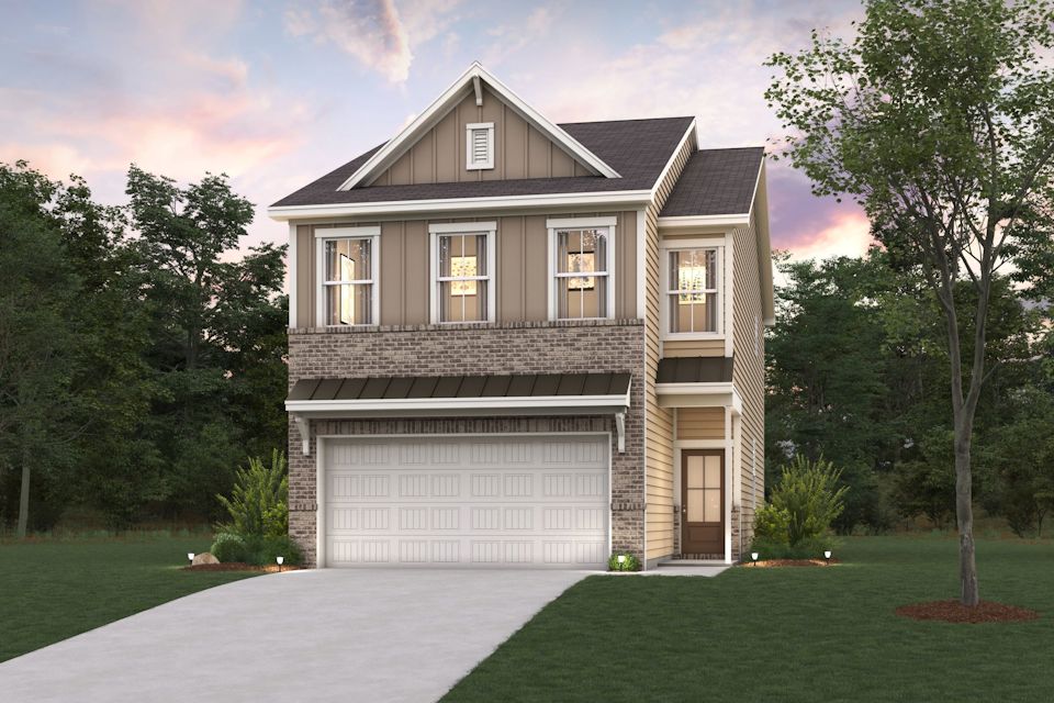 A house with a garage and trees.