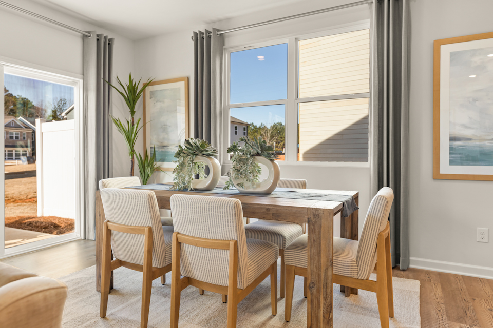 A dining room table with chairs.