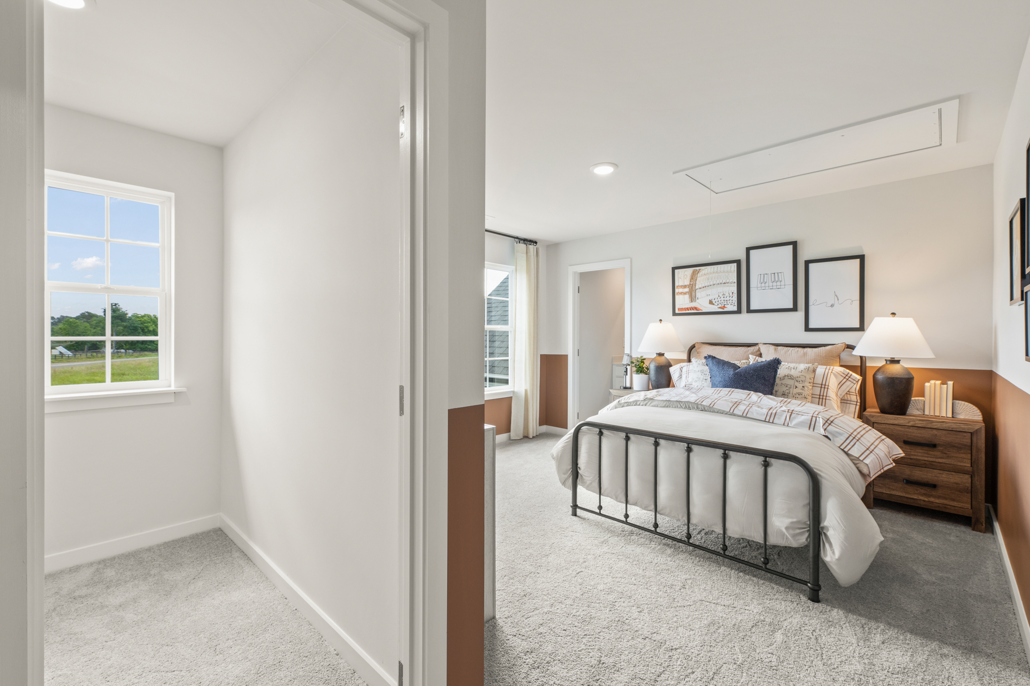 A bedroom with a bed and a lamp.