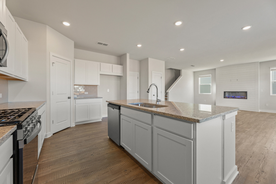 A kitchen with white cabinets.