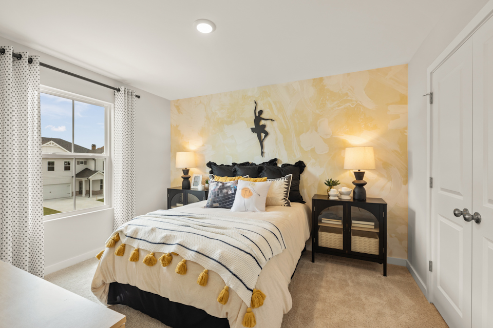 A bedroom with a bed and a table.
