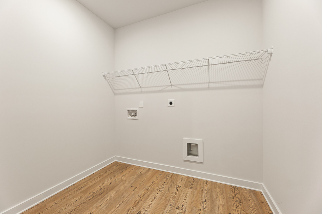 A room with a wood floor and a metal railing.