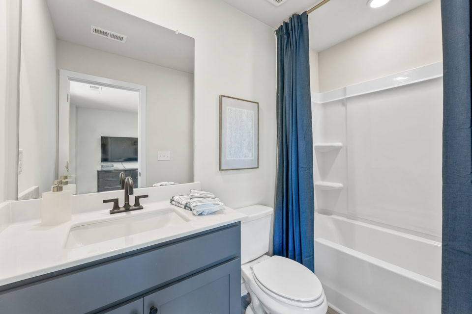 A bathroom with a sink toilet and a bathtub.