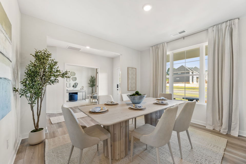 A dining room with a large table.