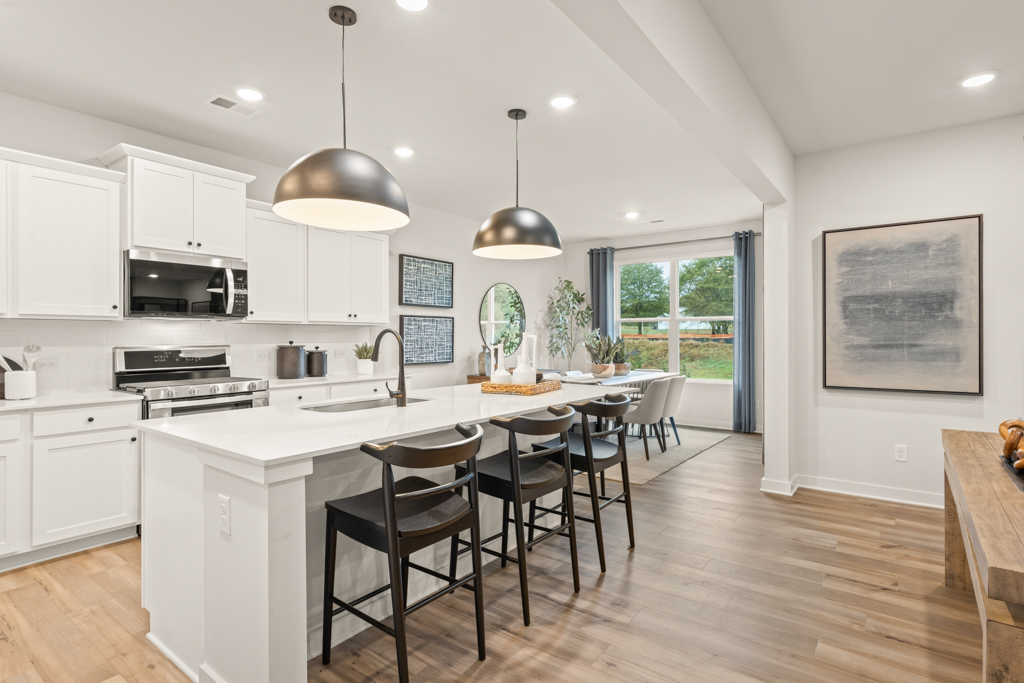 A kitchen with white cabinets.