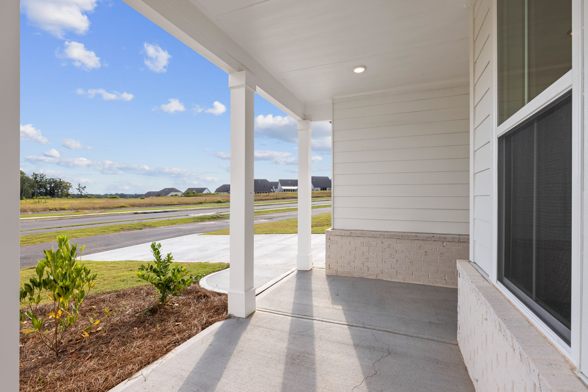 A building with a walkway and grass.