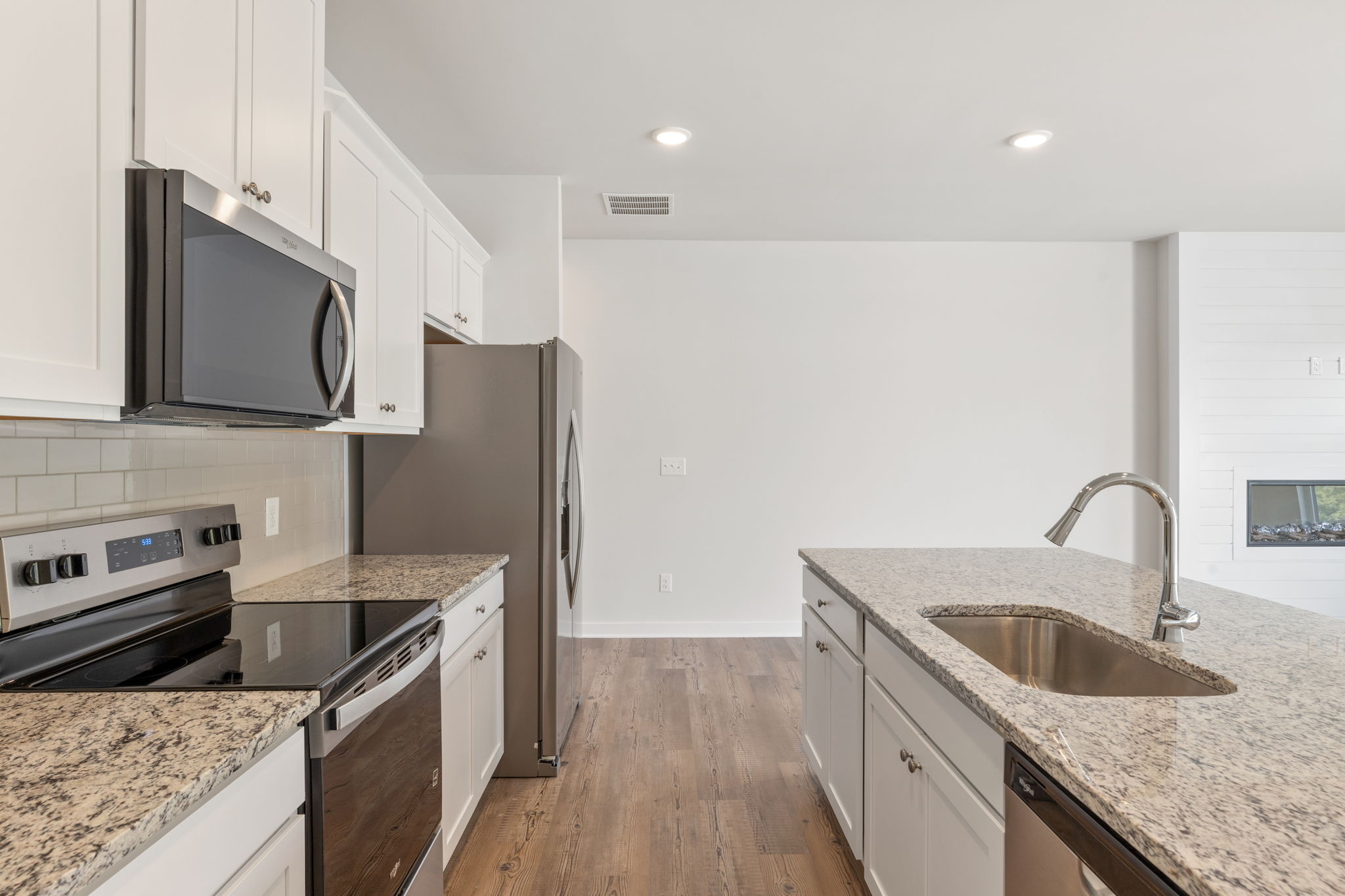A kitchen with white cabinets.
