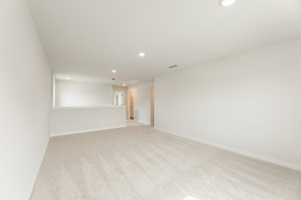A long hallway with white walls.