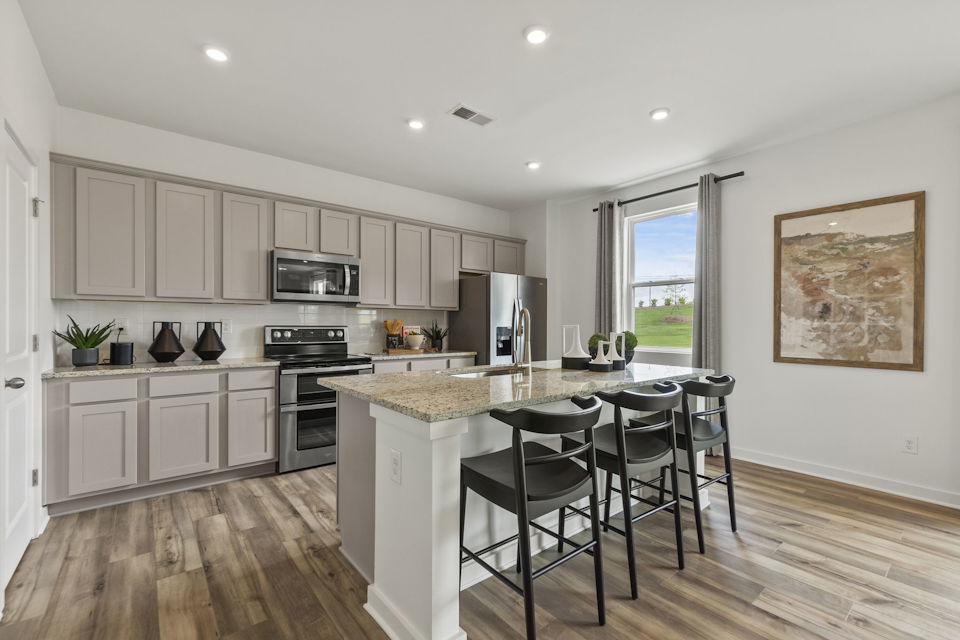 A kitchen with a marble island.