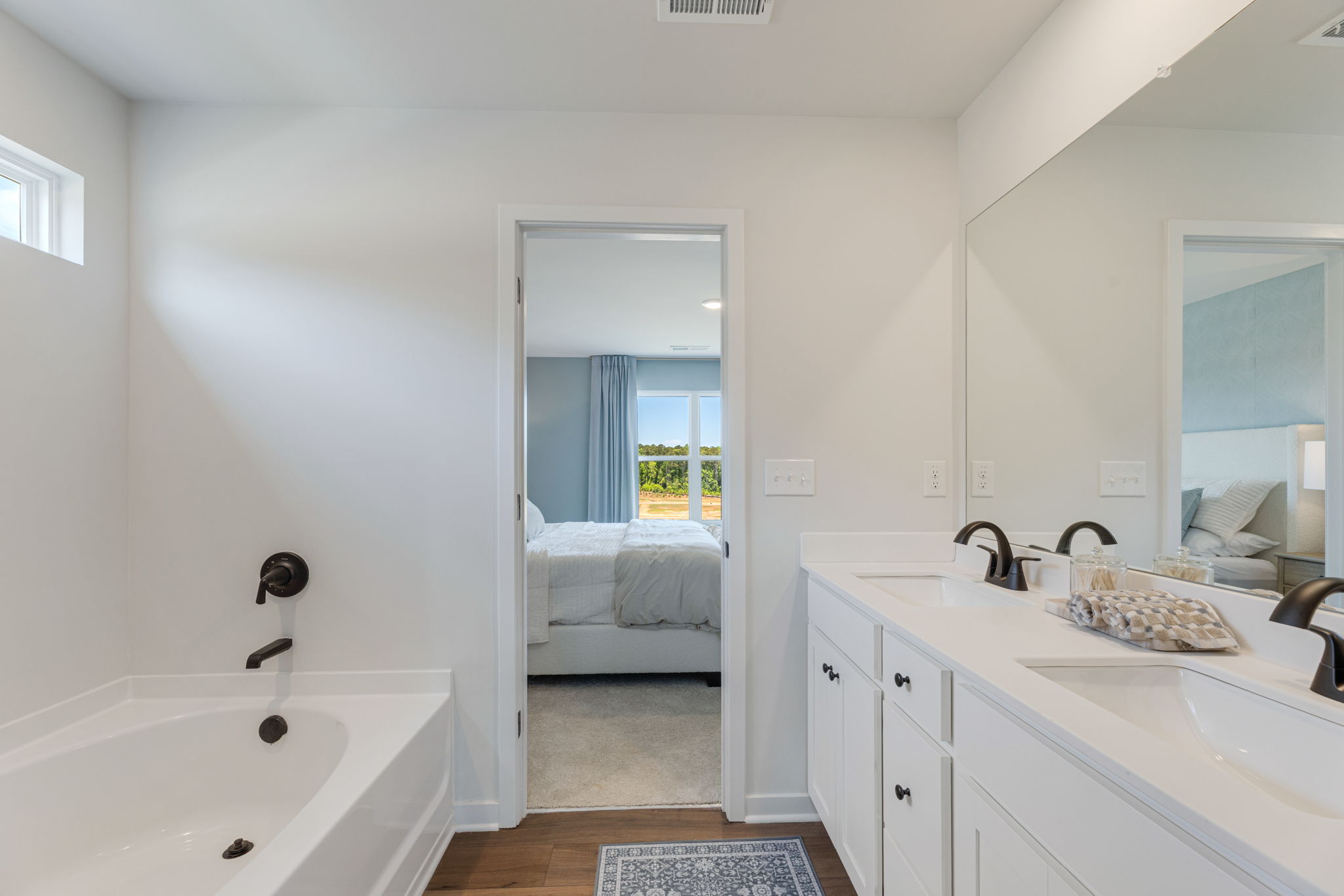 A bathroom with a tub sink and a bathtub.