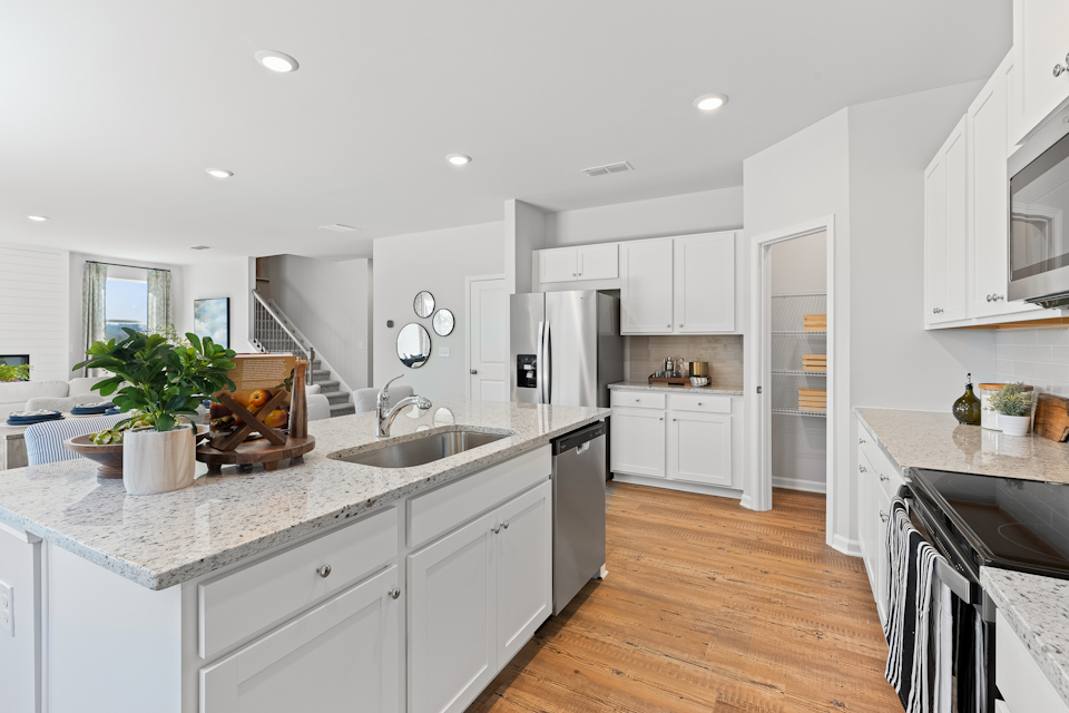 A kitchen with white cabinets.