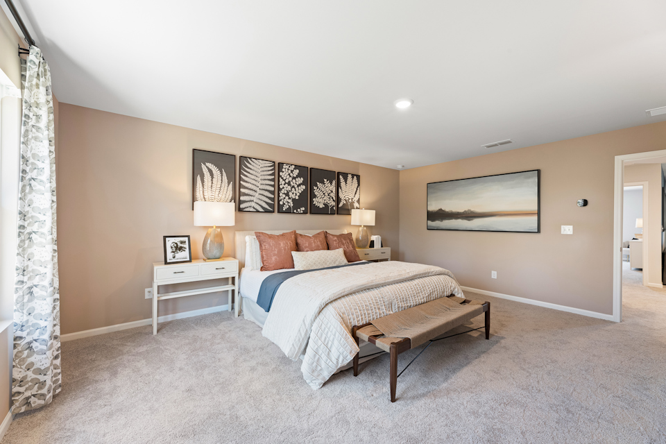 A bedroom with a bed and lamps.