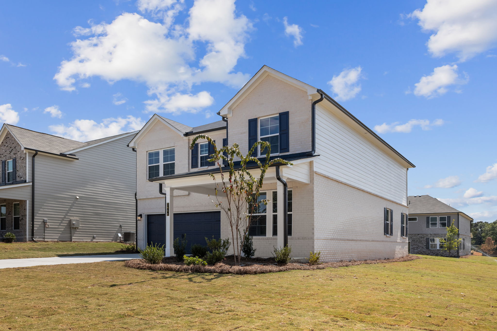 A house with a tree in the front.