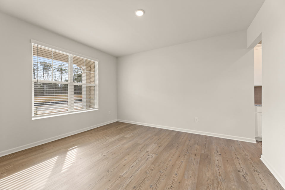 A room with a wood floor and a window.