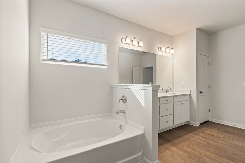 A bathroom with a tub and sink.