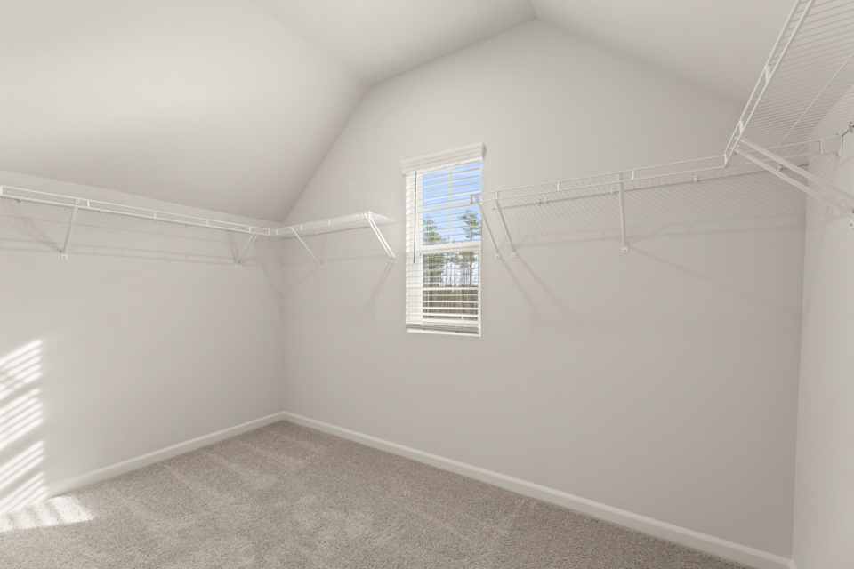 A room with a window and a carpet.