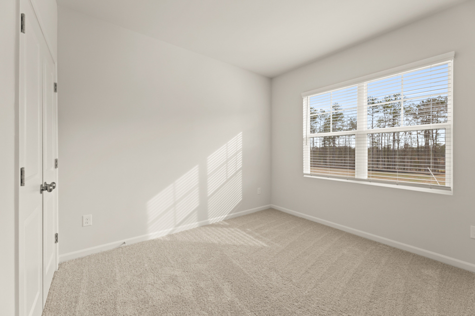 A room with a window and a door.