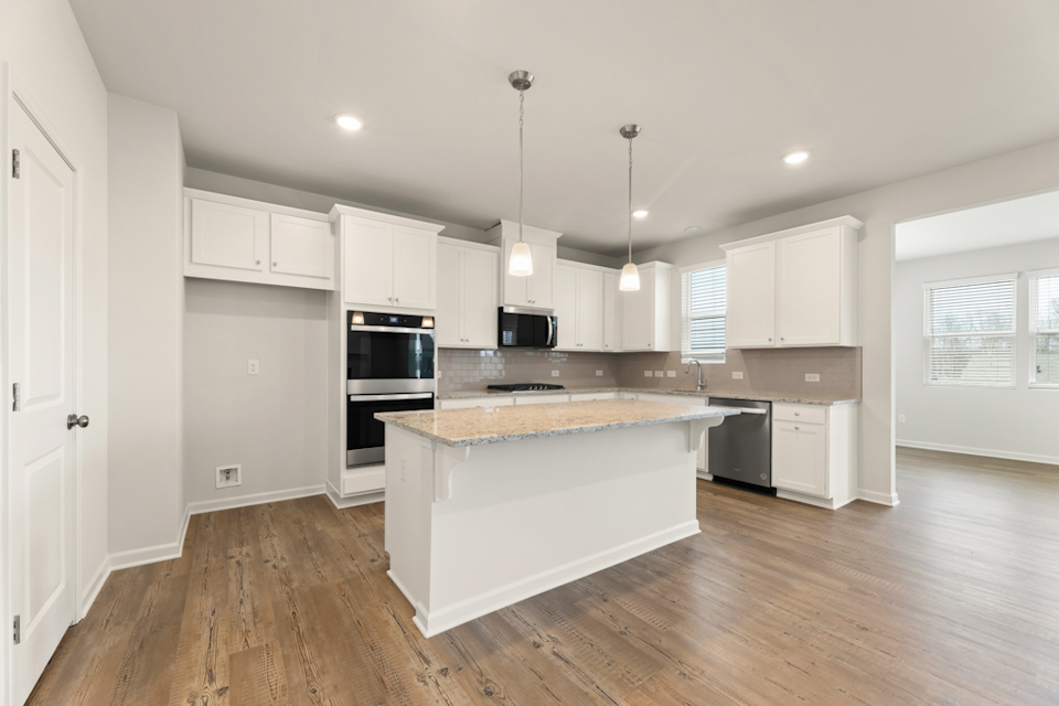 A kitchen with white cabinets.
