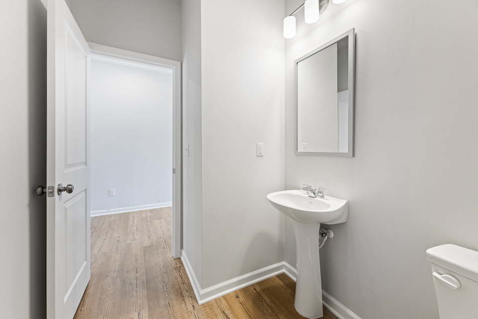 A bathroom with a sink and a mirror.