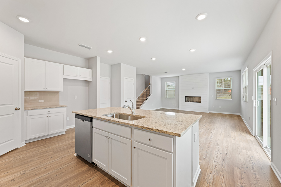A kitchen with white cabinets.