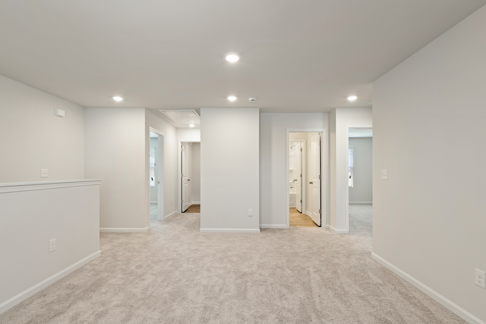 A long hallway with white walls.