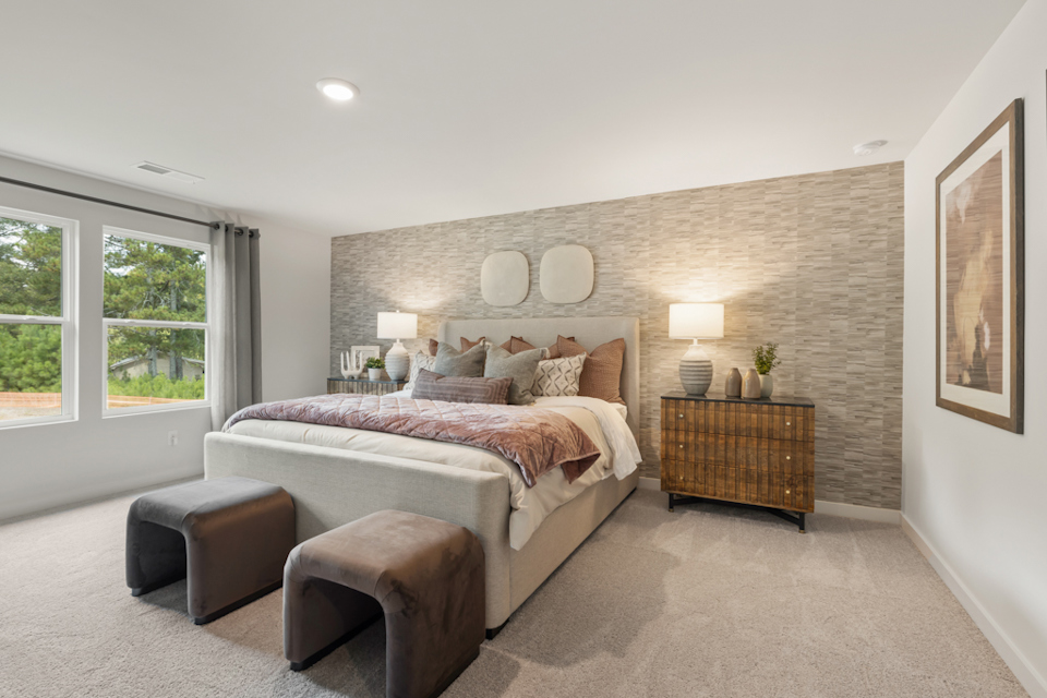 A bedroom with a bed and a couch.