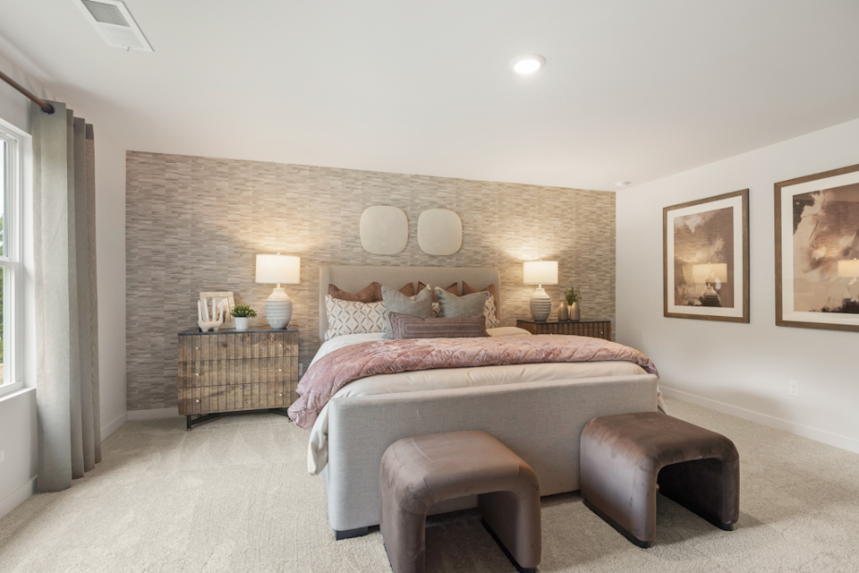 A bedroom with a bed and a couch.