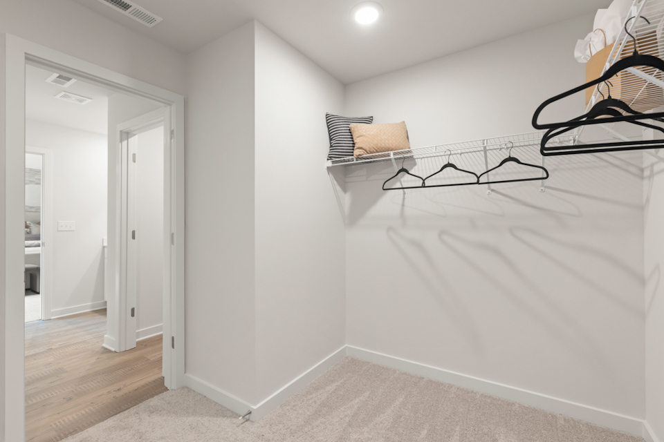 A white room with a black railing.