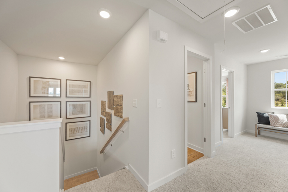 A room with white walls and pictures on the wall.