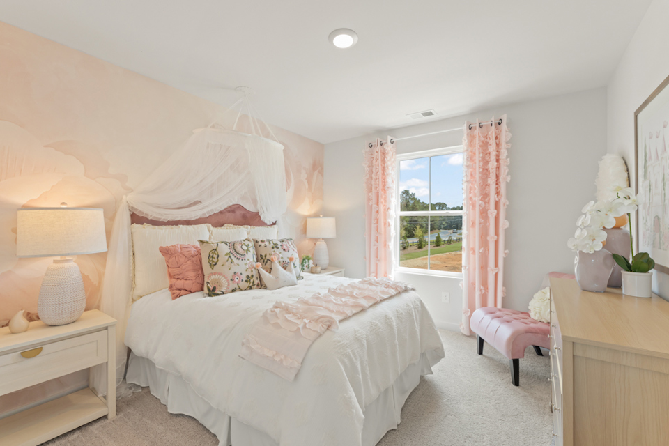 A bedroom with a bed and lamps.
