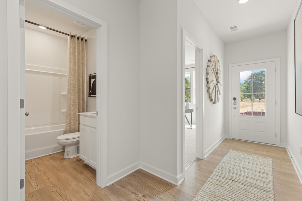 A bathroom with a wood floor.