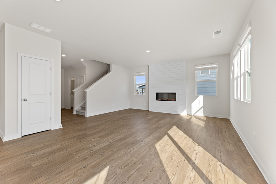 A room with a wood floor and white walls.